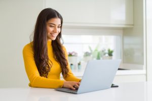 Smiling woman attends online therapy in florida for anxiety with counseling solutions of broward for online counseling in Miramar, FL