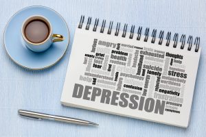 infographic about depression next to coffee and a pin depicting how challenging depression is. Words on the pad include "depression. angry. stress. thoughts. psychology. lonely. suicide. exhausted. hopeless. negativity. pressure. help." Get depression treatment for women in florida with counseling solutions of broward