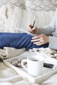 Woman writing in journal about her health anxiety in Miramar, FL. You can start online therapy in Florida for codependency, self-sabotage, imposter syndrome, post-divorce counseling and divorce recovery and more with online counseling for women with anxiety in Miramar, FL. Meet with online therapist in Florida, Enid.