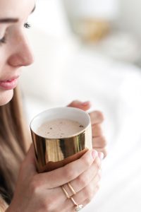 Woman looking at her coffee cup during her morning routine after setting healthy boundaries in Florida. You can get codependency counseling for women in Florida with online therapist Enid to talk about setting healthy boundaries in Miramar, FL