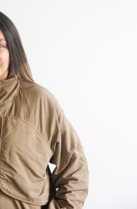 Half of a woman shown standing in a jacket on a white background. You can get online therapy in Florida for codependency and setting boundaries in MIramar, FL from an online therapist.