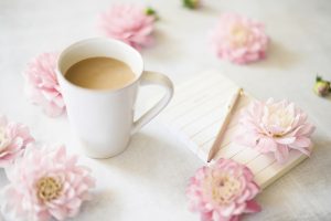 Coffee cup with flowers around and a pad of paper. You can get online therapy in Florida for codependency and setting boundaries in MIramar, FL from an online therapist who specializes in relationship counseling for singles.