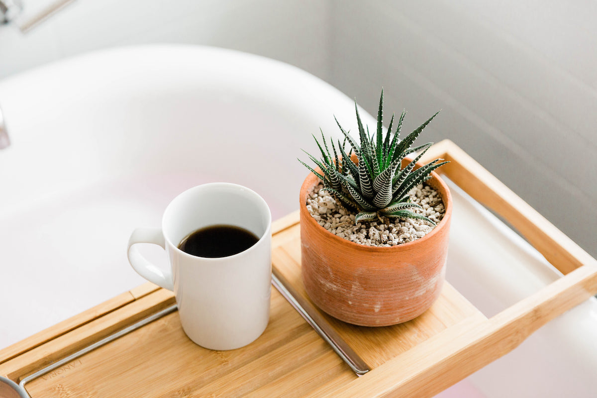 Coffee cup and plant on a wooden tray over the tub. You can practice self care with healthy boundary management for codependency treatment, anxiety treatment, divorce recovery in Miramar, FL and more with online therapy for women in Florida.