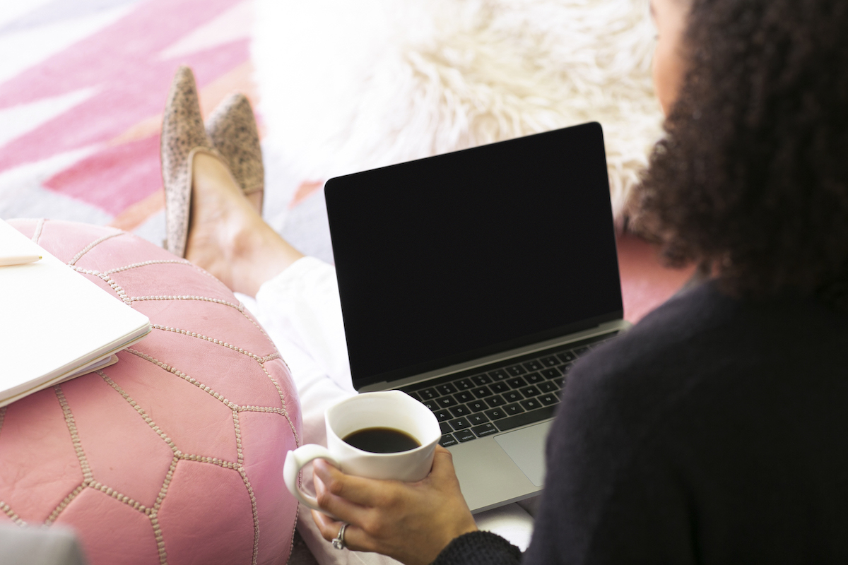 Woman at computer, holding a coffee cup. Navigating healthy boundaries as a professional can be tough. Get codependency treatment in Miramar, FL with online therapy in Florida for women here.