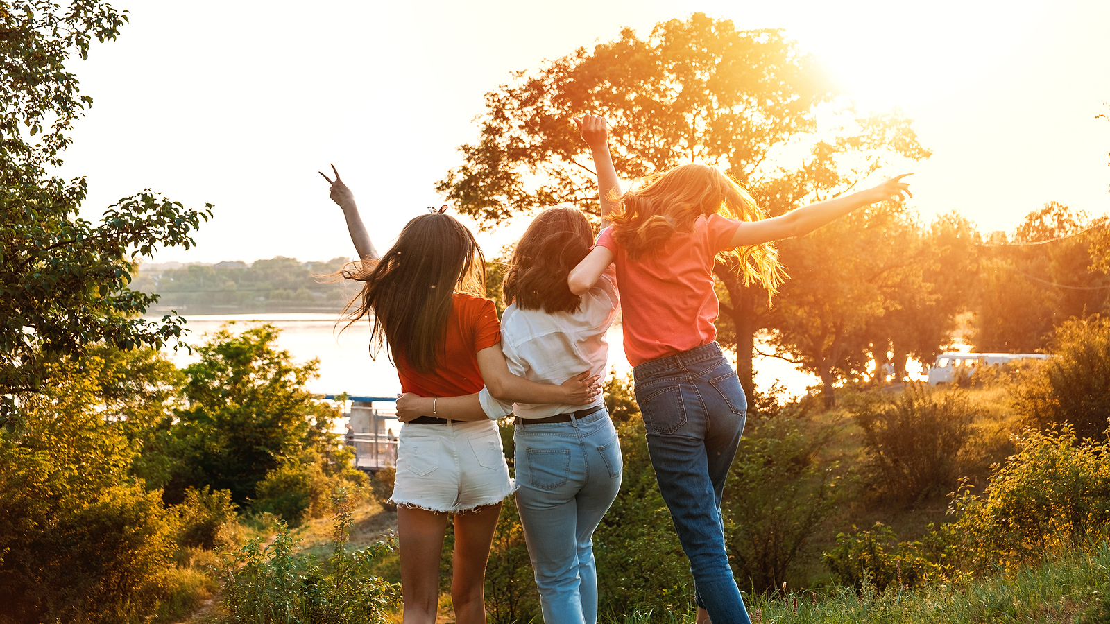 Group of women embracing and holding arms up in the air looking happy and excited outside. Self love, healthy boundaries for women in florida, codependency treatment in Miramar, FL and more are available via online therapy in Florida here! 