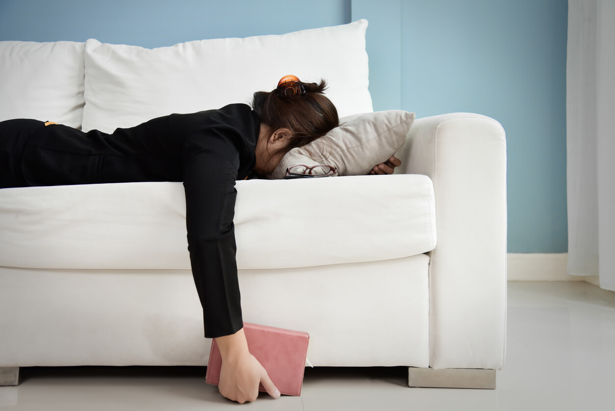 Woman laying face-down on a sofa looking upset. HSP women in Florida can deal with anxiety more acutely than others. Learn about anxiety symptoms from a Mirmar, FL therapist doing online therapy in Florida here.